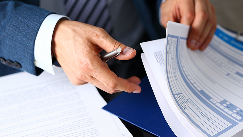 Business man flipping through documents