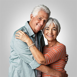 Senior couple hugging because they're finally out of debt.