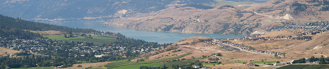 Okanagan lake surrounded by yellow hills.
