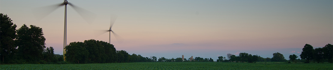 Windmills turning at sunrise