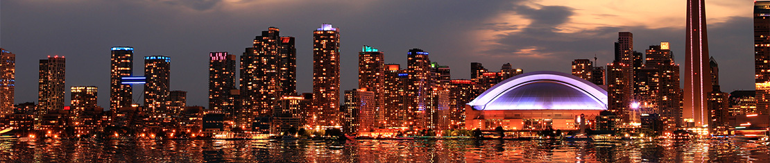 Downtown Toronto skyscrapers surrounding the Rogers Centre at night.